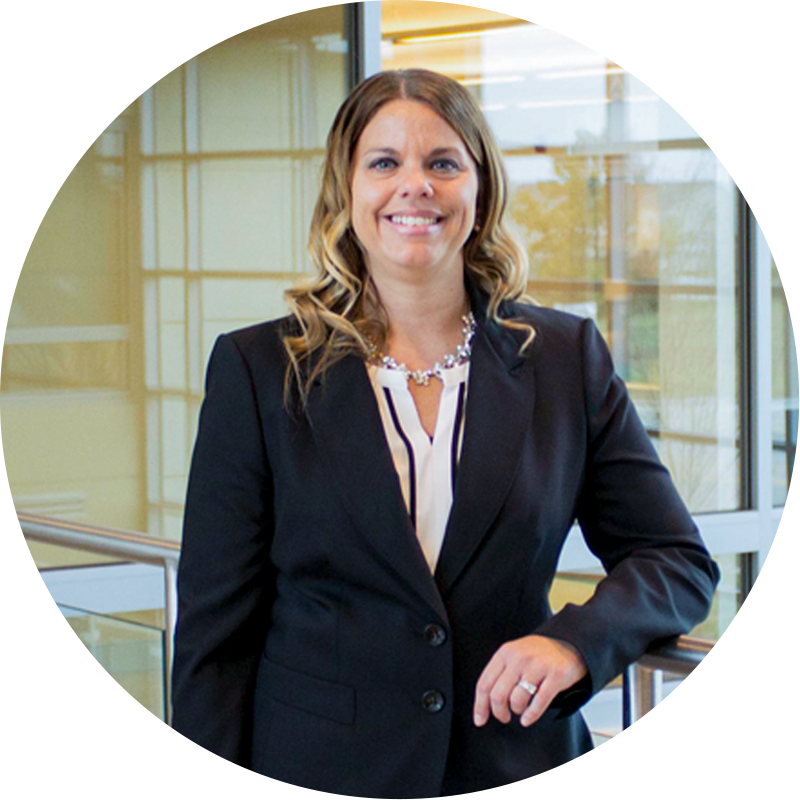 LPL Registered Alltru Representative Amanda Barcliff is pictured smiling in a black suit while standing in the Wentzville Alltru Credit Union branch. Photo is inside of a circle shape.