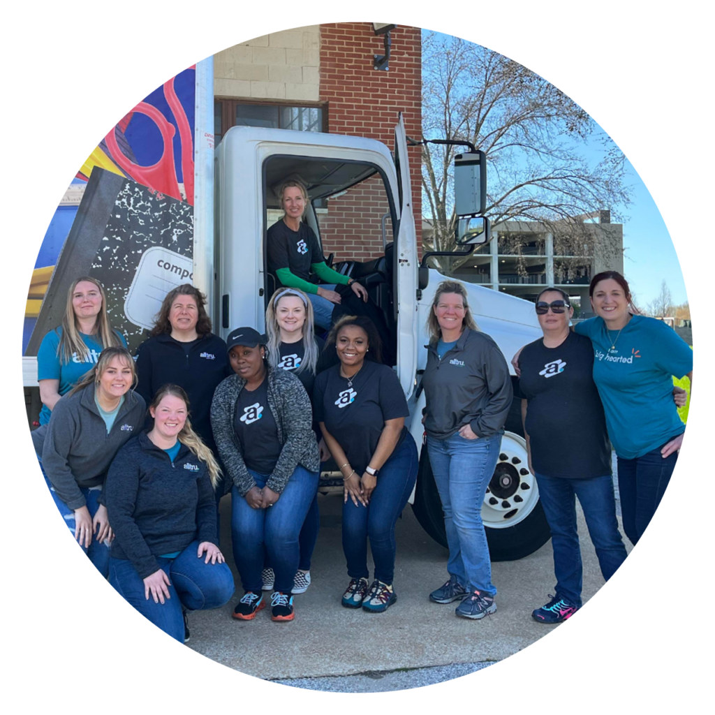 Alltru Credit Union Volunteer Day at KidSmart. Lone is pictured inside of the KidSmart truck with a group of Alltru employees.