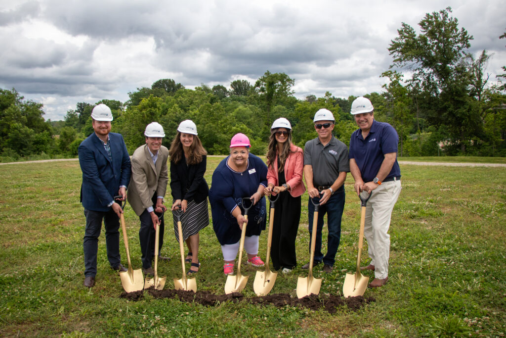 A group of executives and guests celebrate the groundbreaking of the next Alltru branch