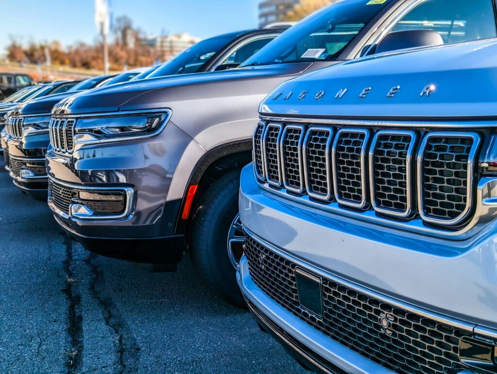 A line of Wagoneer SUVs at a car dealership