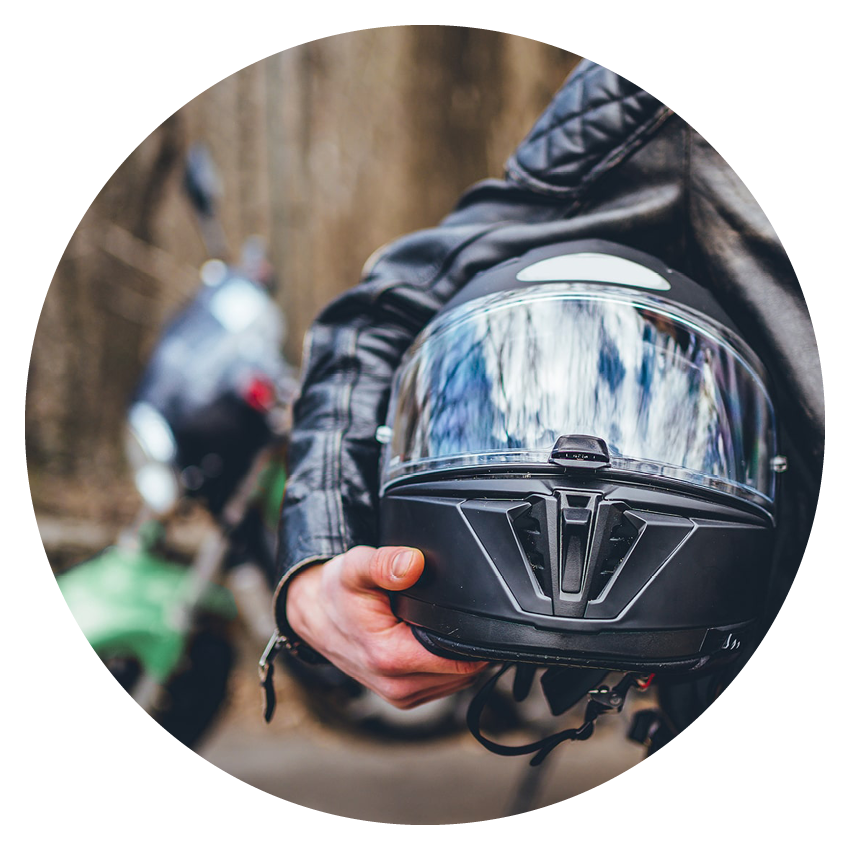 Auto Loans | Alltru Credit Union | St. Louis, MO A photo of a motorcycle helmet being held under an arm, the photo is in a circle shape