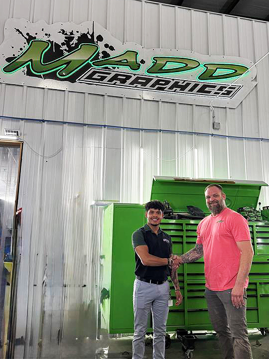 Alltru employee Prov shaking hands with the MADD graphics owner