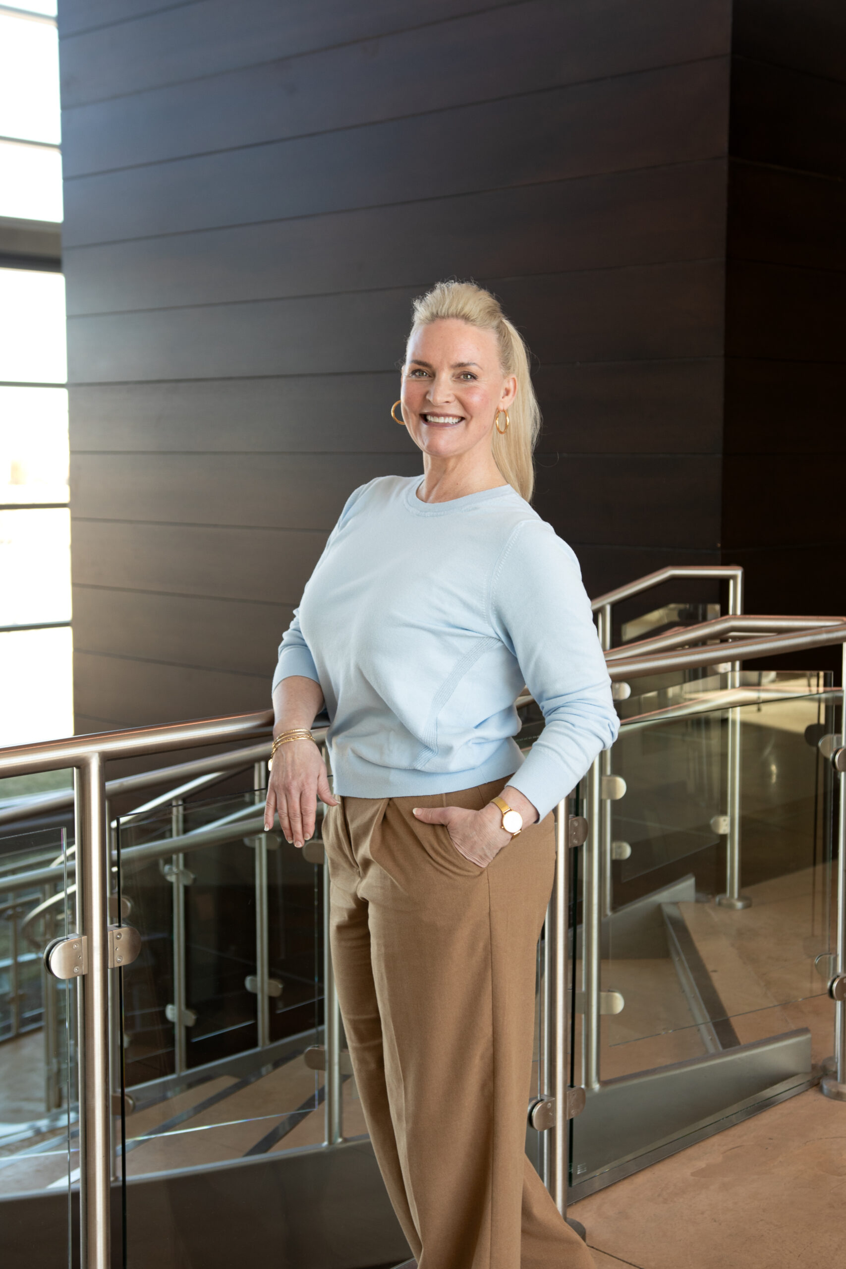 Tracy Verner standing with her arm on a railing in the Wentzville branch