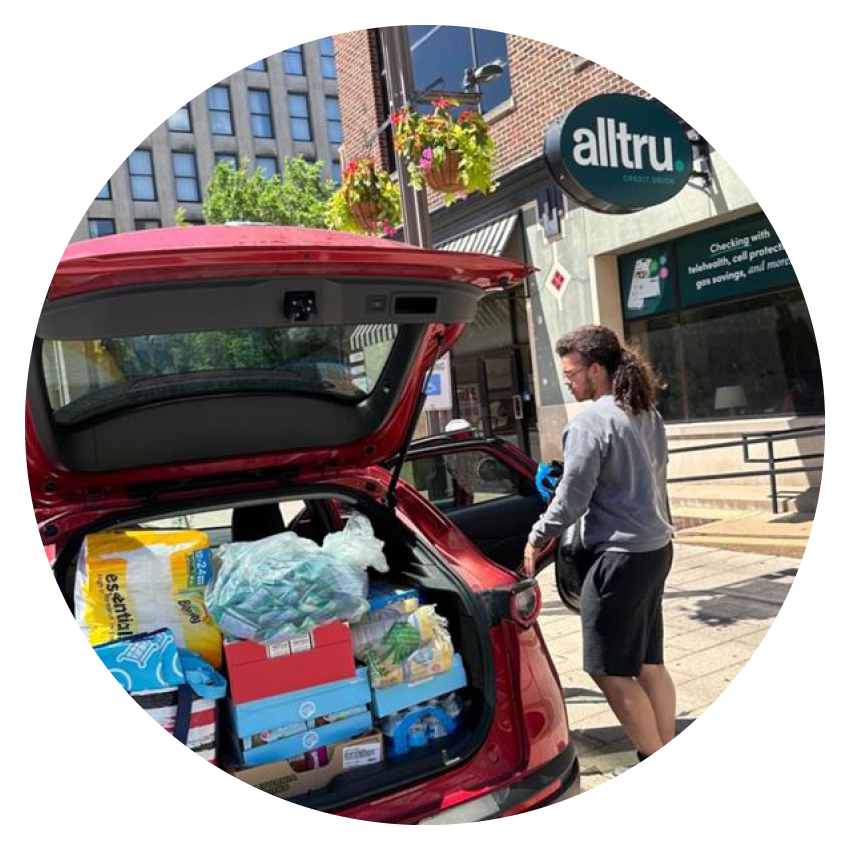 A photo of an Alltru member unpacking emergency supplies outside the Downtown branch