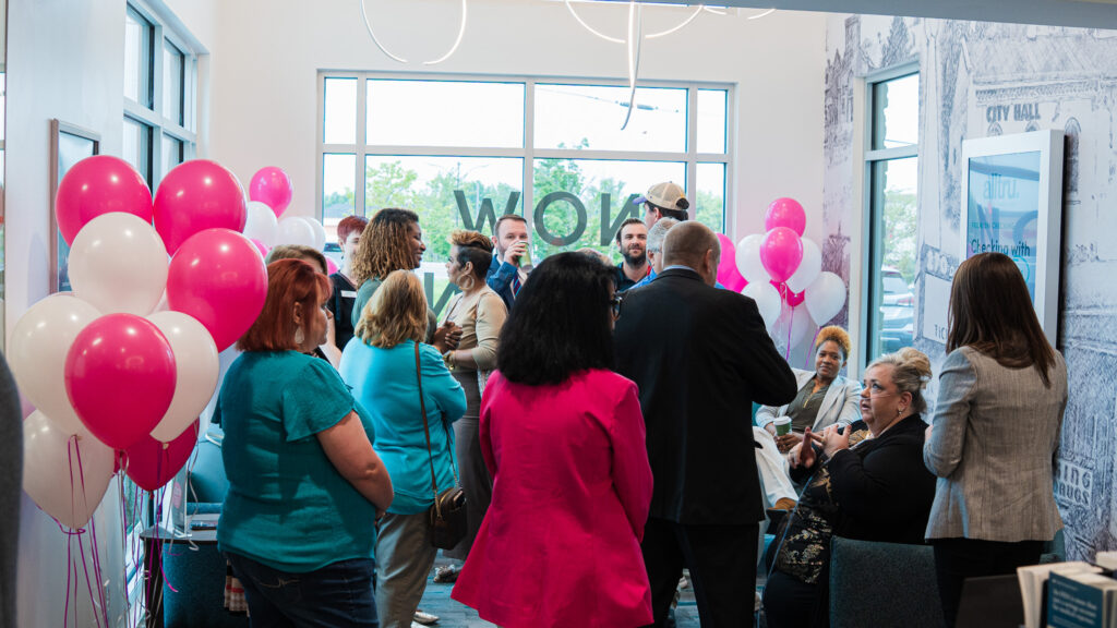 A group photo inside Alltru's Florissant branch during the ribbon cutting