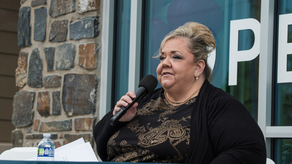 Alltru's CEO Michelle Rosner speaking outside the Florissant branch at the ribbon cutting ceremony
