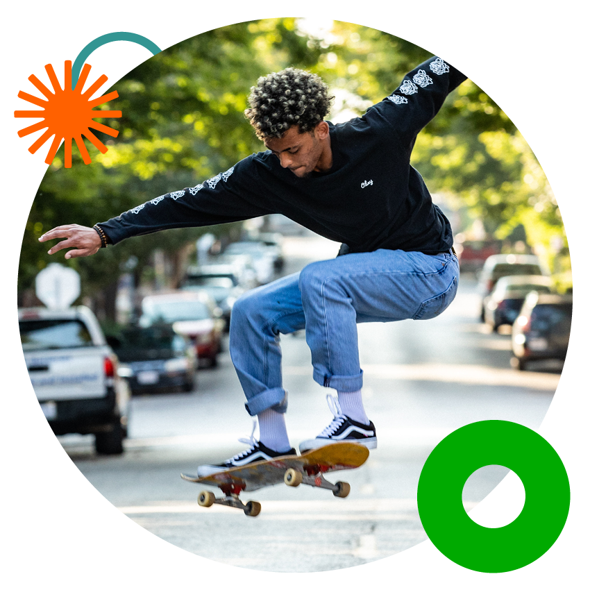 Teen Checking | Alltru Credit Union | St. Louis, MO Alltru member Andrew on a skateboard in the street. Decorative embellishments frame the circle photo